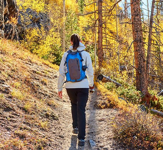women hiking through fall woods