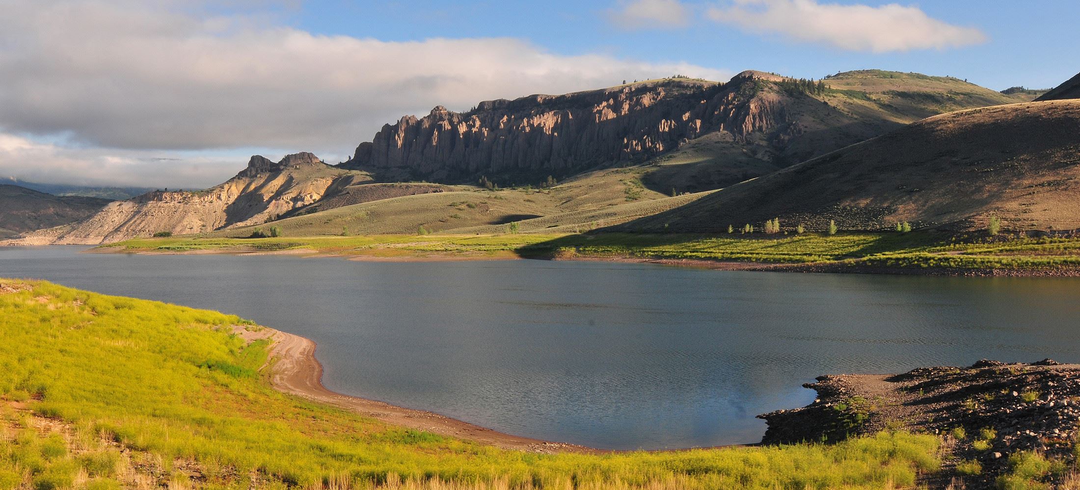 a lake with mountains behind it